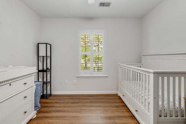 261 Mossy Oak Way, Mount Pleasant, SC 29464 - unfurnished bedroom featuring light wood finished floors, baseboards, and a nursery area