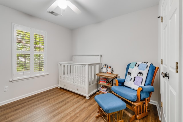261 Mossy Oak Way, Mount Pleasant, SC 29464 - bedroom with wood finished floors, a crib, baseboards, and ceiling fan