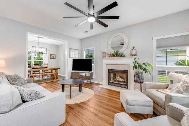 261 Mossy Oak Way, Mount Pleasant, SC 29464 - living room with a ceiling fan, light wood-type flooring, a chandelier, a tile fireplace, and baseboards