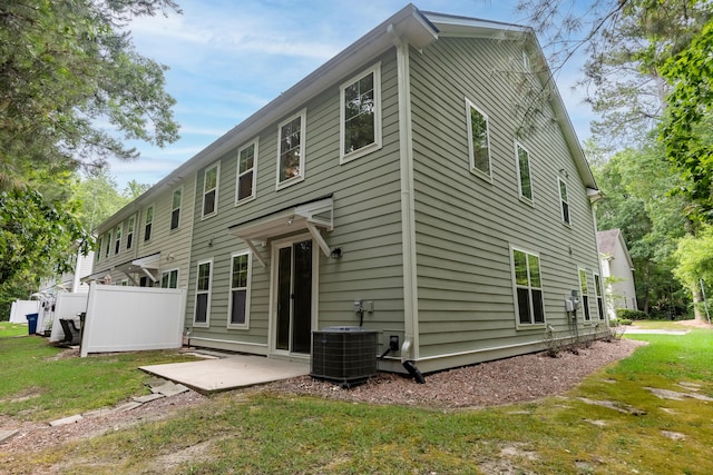 5001 Hay Bale Ct, Summerville, SC 29485 - rear view of house featuring cooling unit, a patio area, and a lawn