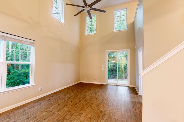5001 Hay Bale Ct, Summerville, SC 29485 - unfurnished living room featuring a high ceiling, healthy amount of natural light, a ceiling fan, wood finished floors, and baseboards