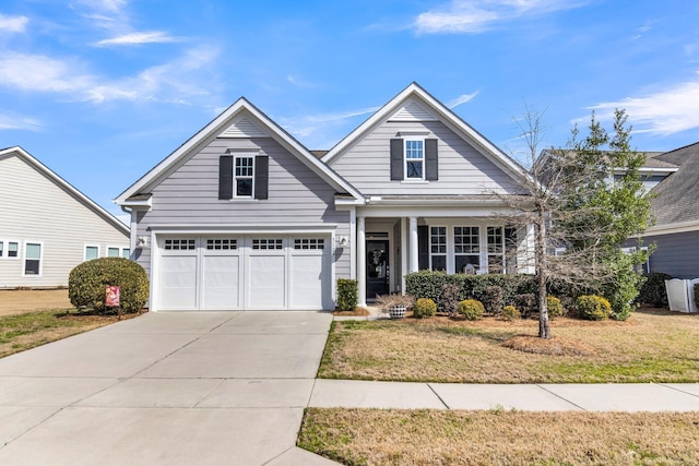 view of front of house featuring a garage, concrete driveway, and a front yard