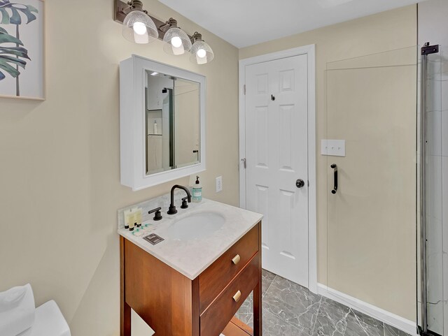 bathroom with vanity and marble finish floors