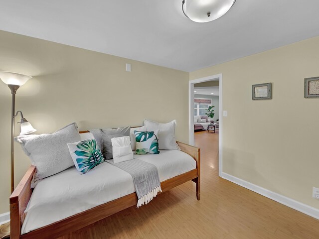 bedroom with wood finished floors and baseboards
