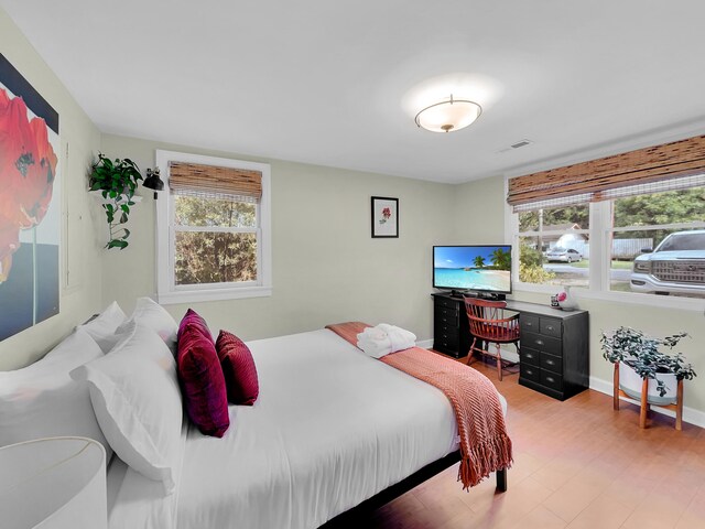 bedroom with multiple windows and baseboards