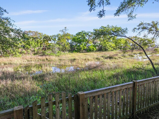 view of yard with a water view and fence