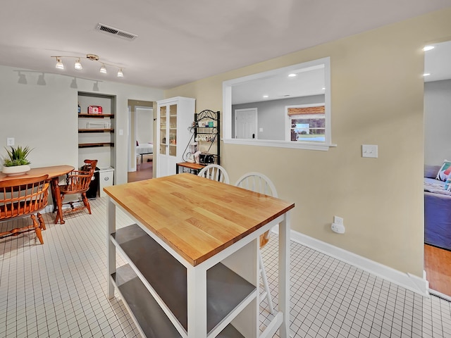 dining area featuring tile patterned floors and baseboards