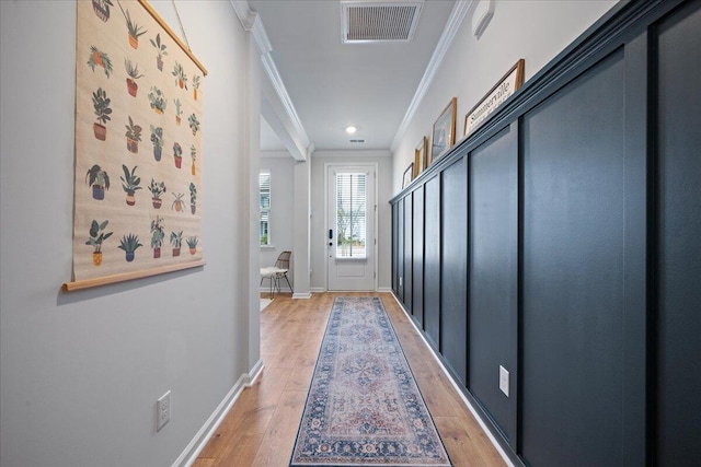 doorway to outside featuring visible vents, baseboards, ornamental molding, recessed lighting, and light wood-style flooring