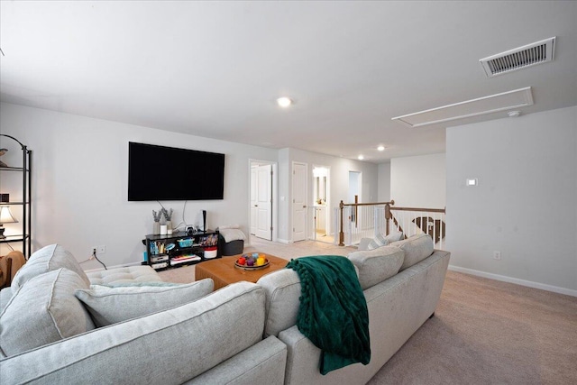 living room with visible vents, recessed lighting, baseboards, light colored carpet, and attic access