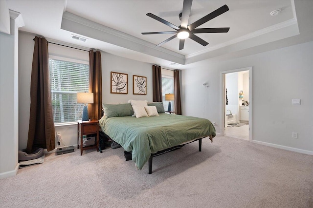 bedroom with a tray ceiling, carpet, visible vents, and ornamental molding