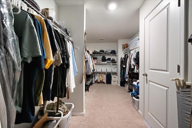 walk in closet with visible vents and carpet floors