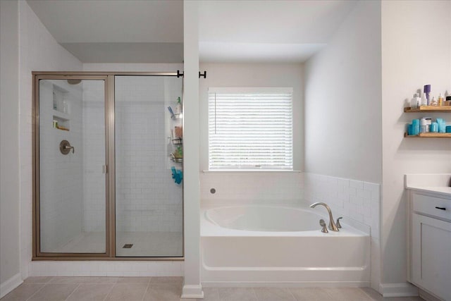 full bath featuring a bath, a shower stall, tile patterned floors, and vanity