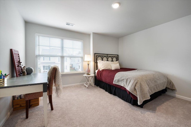 bedroom with visible vents, baseboards, and carpet