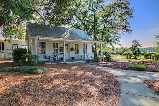 view of front of house with a porch and metal roof