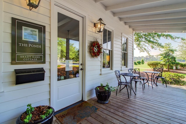 view of exterior entry featuring covered porch