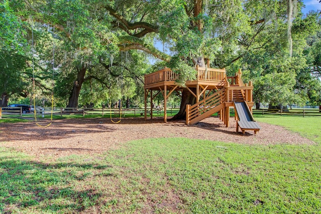 view of play area with a lawn and a deck