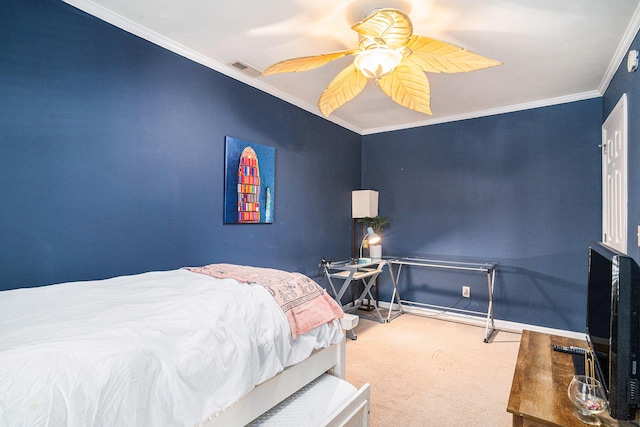 carpeted bedroom with ornamental molding and ceiling fan