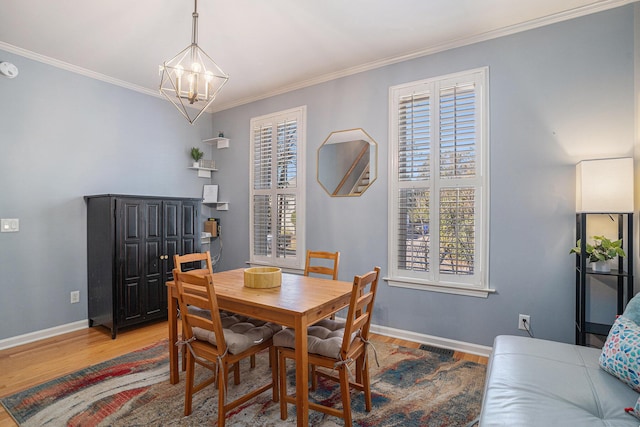 dining space featuring crown molding, wood-type flooring, and plenty of natural light