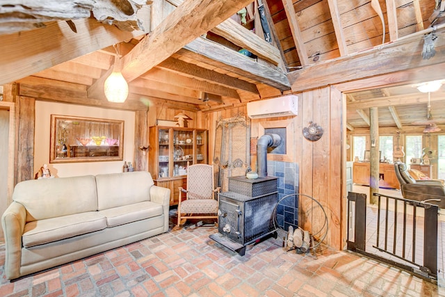 living room featuring wood walls, a wood stove, a wall mounted AC, wood ceiling, and beam ceiling