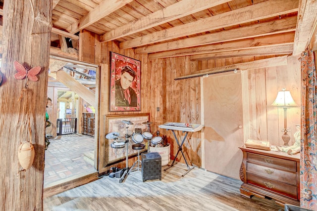 misc room featuring wood ceiling, wooden walls, beam ceiling, and hardwood / wood-style flooring