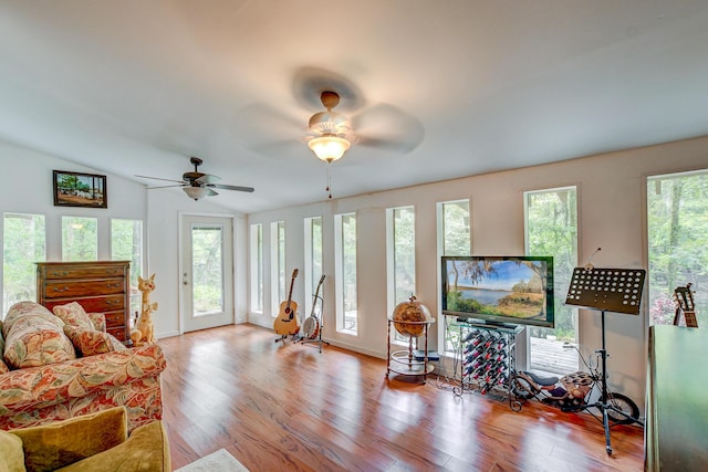 living room with vaulted ceiling, ceiling fan, and light hardwood / wood-style flooring