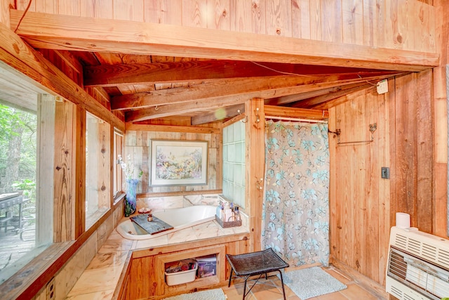 interior space featuring wooden walls, heating unit, and a bathtub