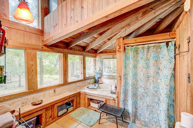 bathroom with vaulted ceiling and tile patterned floors