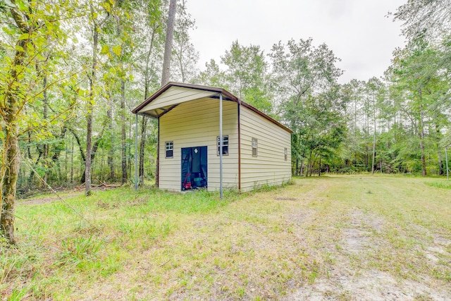 view of outdoor structure featuring a lawn