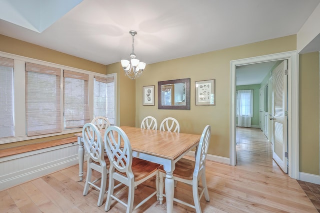 dining room featuring a notable chandelier and light hardwood / wood-style floors