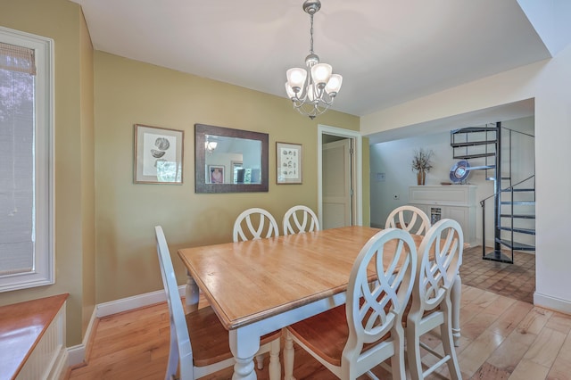 dining area featuring a chandelier and light hardwood / wood-style flooring