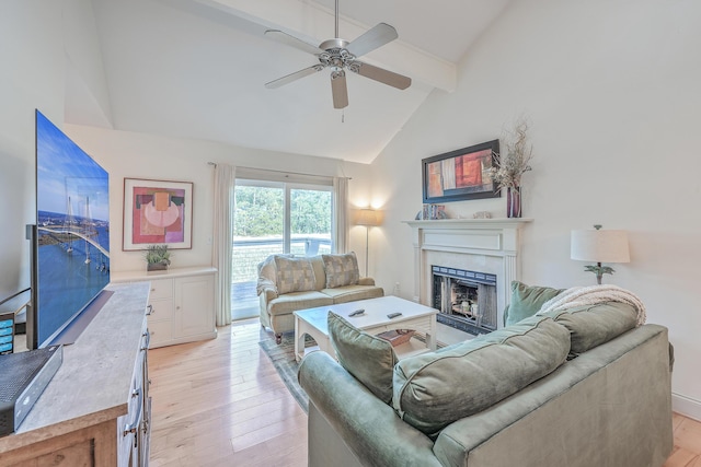 living room with ceiling fan, vaulted ceiling with beams, and light hardwood / wood-style floors