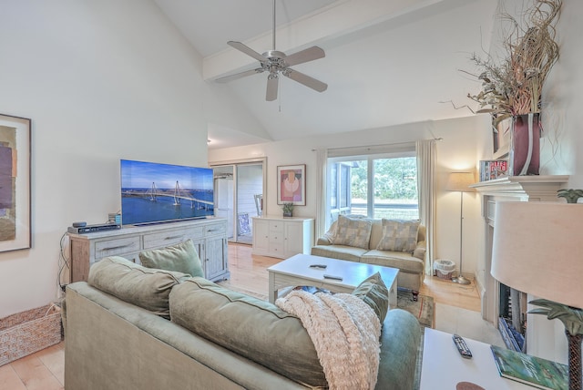 living room featuring light wood-type flooring, ceiling fan, and high vaulted ceiling