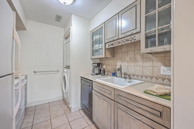 kitchen with dishwasher, light tile patterned floors, white fridge, decorative backsplash, and sink