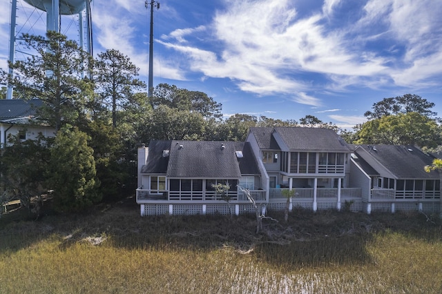 rear view of property with a sunroom