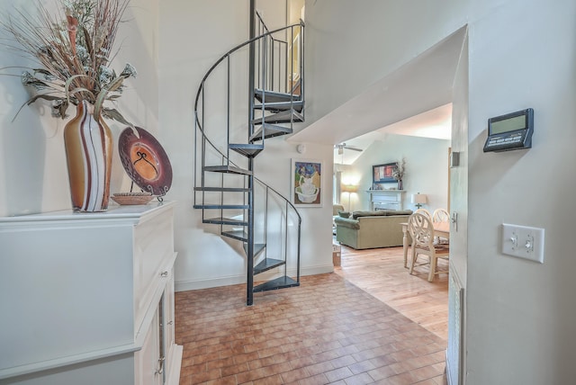 staircase featuring ceiling fan