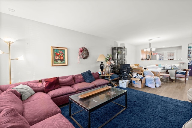 living room featuring hardwood / wood-style flooring and a notable chandelier