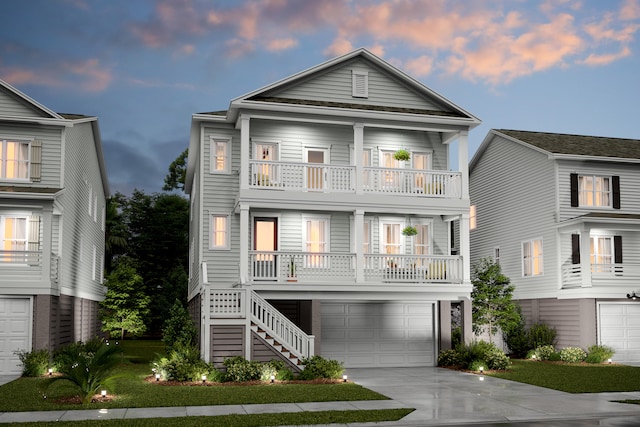 raised beach house with a porch, stairway, an attached garage, a balcony, and driveway