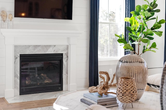 sitting room featuring wood finished floors and a high end fireplace