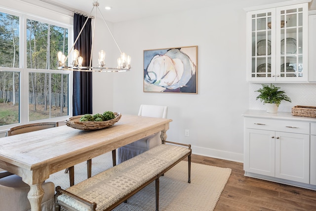 dining room featuring dark wood-style floors, recessed lighting, a notable chandelier, and baseboards