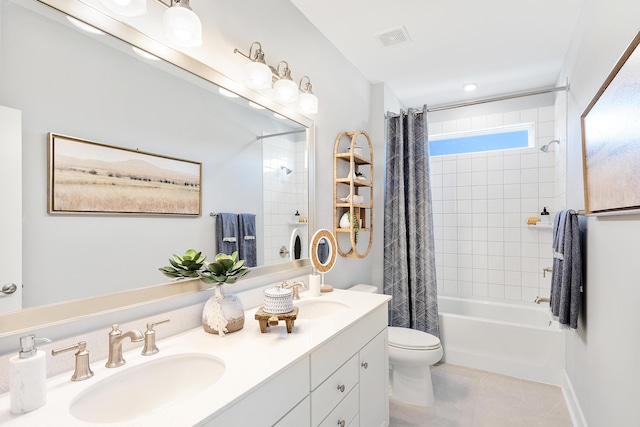 bathroom featuring toilet, shower / bath combination with curtain, visible vents, and a sink