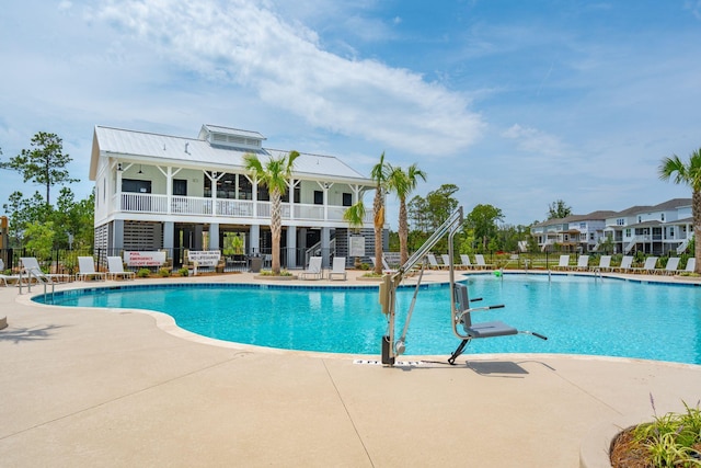 pool featuring stairs, a patio, and fence