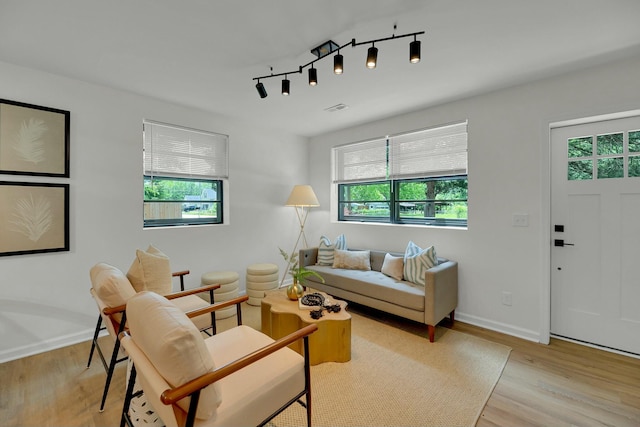 living room with light wood-style flooring and baseboards