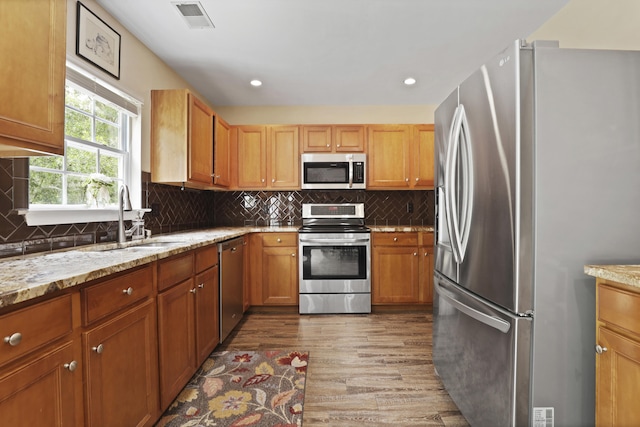 72 Shadow Moss Dr, Beaufort, SC 29906 - kitchen featuring appliances with stainless steel finishes, wood finished floors, tasteful backsplash, light stone countertops, and recessed lighting