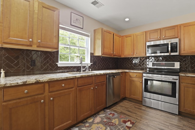 72 Shadow Moss Dr, Beaufort, SC 29906 - kitchen with stainless steel appliances, dark wood finished floors, light stone countertops, tasteful backsplash, and recessed lighting