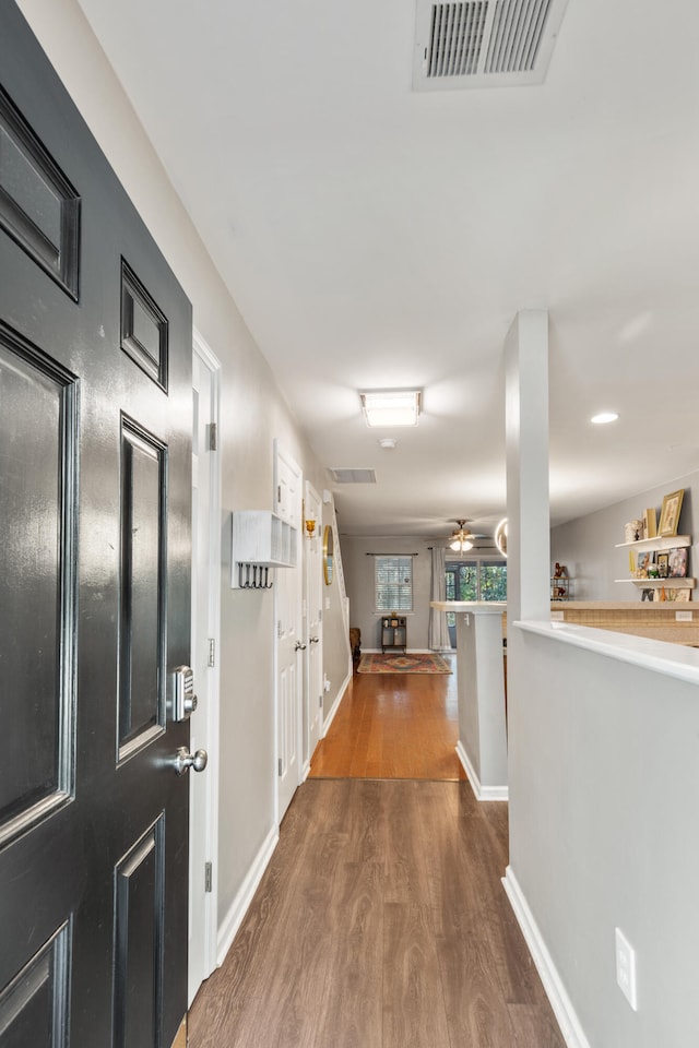 hall with hardwood / wood-style floors