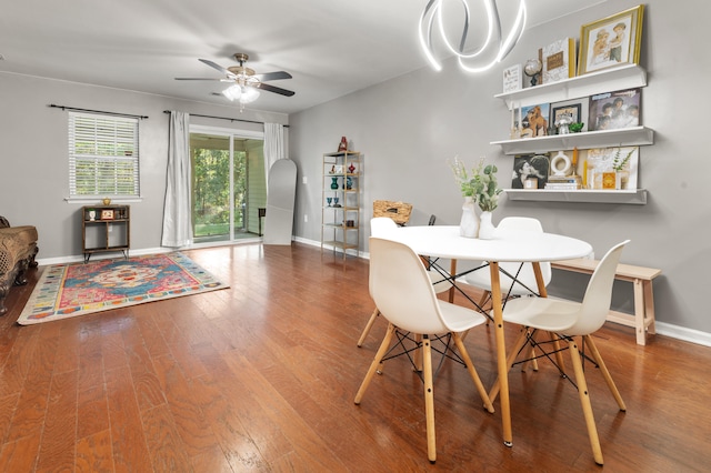 dining space with hardwood / wood-style flooring and ceiling fan