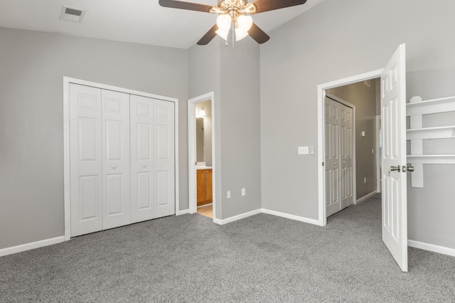 unfurnished bedroom with light colored carpet, ceiling fan, vaulted ceiling, and connected bathroom