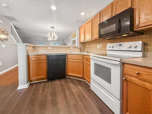 kitchen with black appliances, dark hardwood / wood-style flooring, pendant lighting, sink, and kitchen peninsula