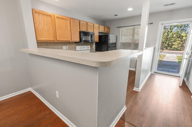 kitchen featuring light wood-type flooring, black appliances, kitchen peninsula, and backsplash