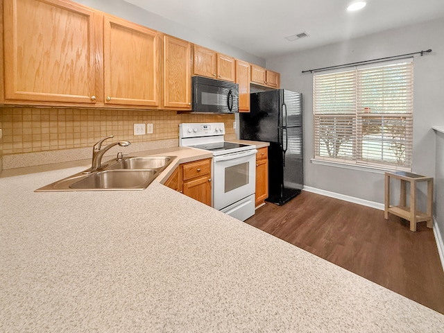 kitchen featuring dark hardwood / wood-style flooring, sink, backsplash, light brown cabinetry, and white appliances